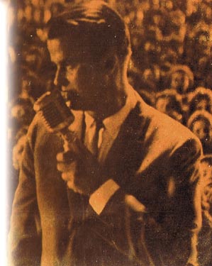 Picture of Dick Clark with a microphone in a crowd